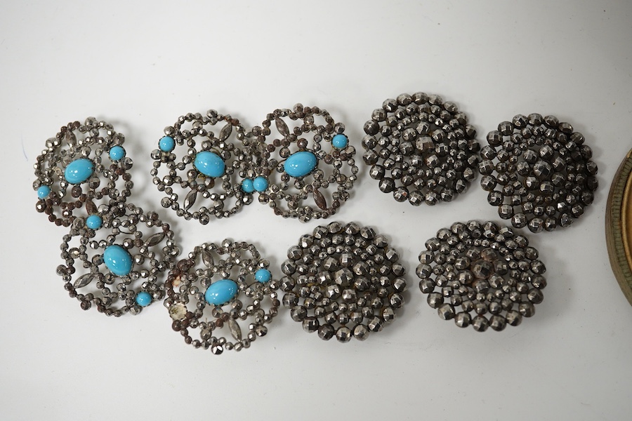 An Edwardian cased set of 6 cut steel buttons with central floral motifs, 20mm, a paste inset ceramic button, a set of 4 cut steel buttons, 33mm and a set of 5 cut steel and simulated turquoise buttons, 33mm. Condition -
